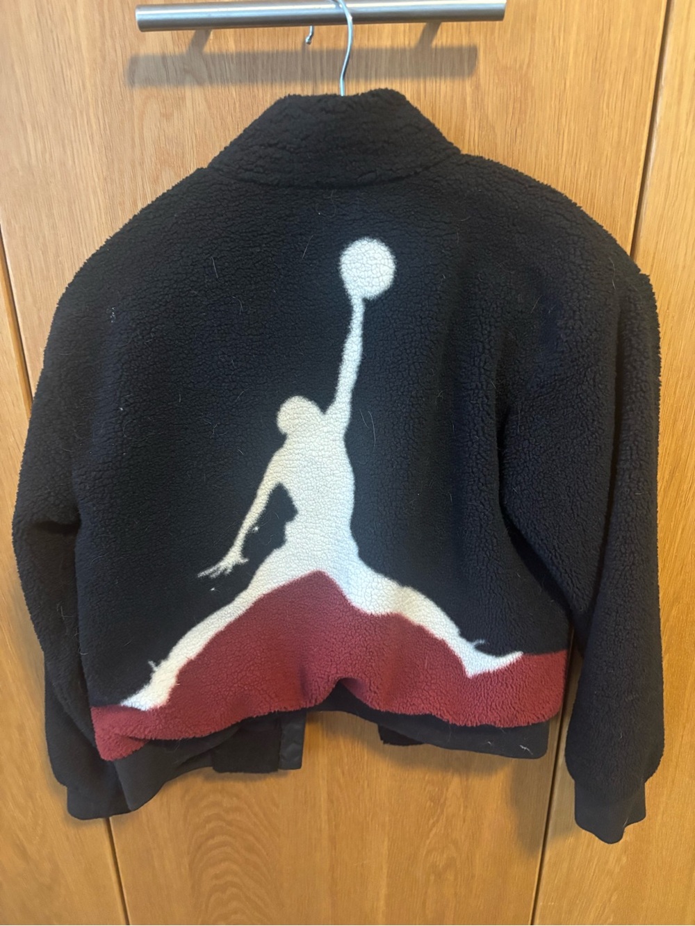 Nike Kids Black Fleece Jacket with White and Red Jumpman Back Graphic